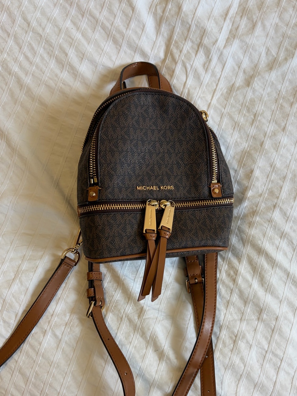Michael Kors “Rhea Mini Backpack” with Gold Hardware